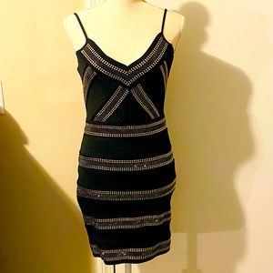 Black bodycon mini dress with gold riveting. Adjustable tank straps with V neck.